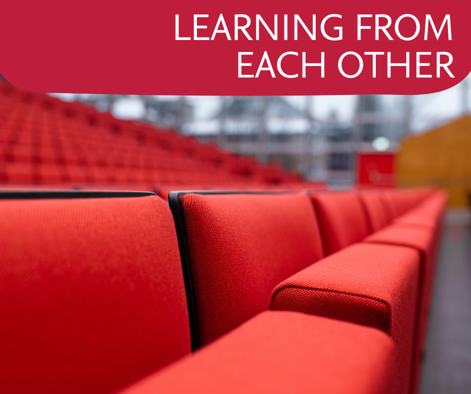 The red chairs of the Audimax are shown.