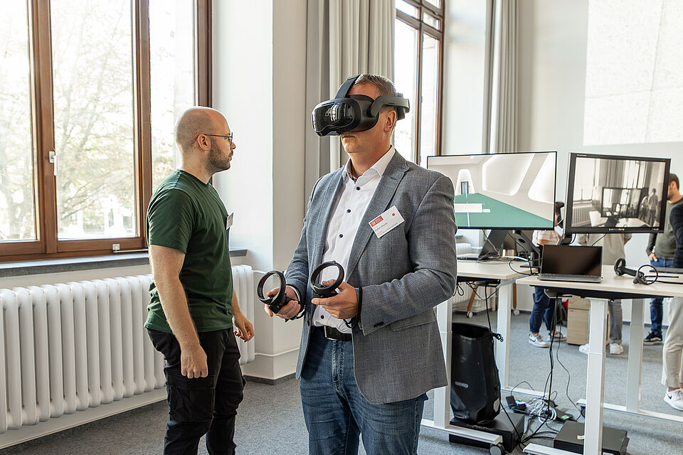 Ein Mann trägt eine VR-Brille und probiert eine VR-Anwendung aus